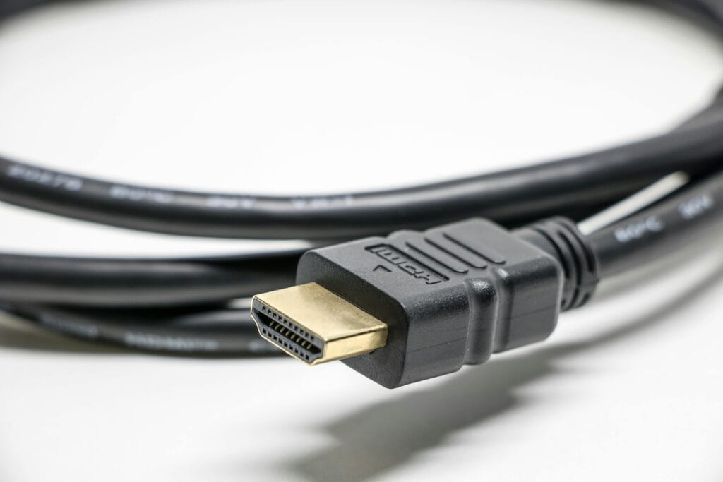 A detailed image of a black HDMI cable with gold connectors on a white background.